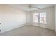 Clean, minimalist bedroom with natural light, plush carpet, and a modern ceiling fan at 403 Tea Olive Ct, Canton, GA 30115
