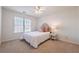 Bedroom showcases natural light from a large window, complementing the neutral tones and plush carpeting at 403 Tea Olive Ct, Canton, GA 30115