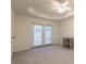 Spacious bedroom with French doors, ceiling fan, and decorative tray ceiling at 403 Tea Olive Ct, Canton, GA 30115