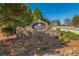 Stone entrance with a 'Bradshaw Estates' sign surrounded by lush greenery and landscaping at 403 Tea Olive Ct, Canton, GA 30115