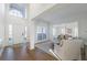 Bright foyer with hardwood floors, high ceilings, and a view into the formal dining room at 403 Tea Olive Ct, Canton, GA 30115