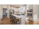 Bright kitchen featuring white cabinets, a center island with seating, and stainless appliances at 403 Tea Olive Ct, Canton, GA 30115