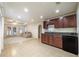 Open-concept living room with a wet bar, mini fridge, plush furniture, and natural light at 403 Tea Olive Ct, Canton, GA 30115