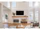 Bright living room with hardwood floors, fireplace, and lots of natural light at 403 Tea Olive Ct, Canton, GA 30115