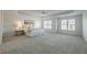 Spacious primary bedroom with tray ceiling, plush carpet, and bright natural light at 403 Tea Olive Ct, Canton, GA 30115