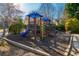 Community playground featuring a slide, climbing structure, and wood-chip ground cover at 403 Tea Olive Ct, Canton, GA 30115