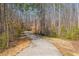 Scenic walking trail winds through a beautiful wooded area, ideal for outdoor activities at 403 Tea Olive Ct, Canton, GA 30115