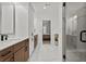 Bright bathroom with marble tile, a glass shower, and double vanity sinks at 800 Castile Ln, Woodstock, GA 30188