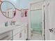 Stylish bathroom features a round mirror, double vanity, and tiled shower-tub combination at 800 Castile Ln, Woodstock, GA 30188