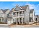 Beautiful gray two-story home featuring a charming front porch, white trim and a two car garage at 800 Castile Ln, Woodstock, GA 30188