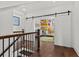 Hallway with dark wood floors leads to Bedroom with sliding barn doors and colorful art at 800 Castile Ln, Woodstock, GA 30188