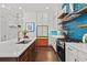 Well-lit kitchen featuring white cabinets, stainless appliances, and a center island at 800 Castile Ln, Woodstock, GA 30188