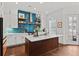 Bright kitchen featuring white cabinets, a center island, and stainless steel appliances at 800 Castile Ln, Woodstock, GA 30188