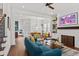 Bright living room featuring modern furniture, a cozy fireplace, and an open floor plan with hardwood floors at 800 Castile Ln, Woodstock, GA 30188