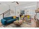 Bright living room with modern furniture, a cozy fireplace, and an open floor plan leading to the dining area at 800 Castile Ln, Woodstock, GA 30188