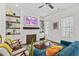 Cozy living room with hardwood floors, a fireplace, a comfortable blue sofa, and stylish decor at 800 Castile Ln, Woodstock, GA 30188