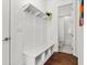 Bright mudroom with built-in bench seating, storage cubbies, and access to a full bath at 800 Castile Ln, Woodstock, GA 30188