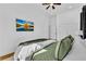 Bedroom featuring a wall-mounted television, cozy decor, and soft, light-colored walls at 1774 Vesta Ave, Atlanta, GA 30337