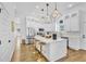 Modern kitchen with white cabinets, stainless appliances, and an island with barstool seating at 1774 Vesta Ave, Atlanta, GA 30337