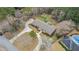 Aerial shot of sprawling home with a long driveway, mature landscaping and a backyard pool at 3003 Hanover Se Ln, Conyers, GA 30094