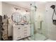 Modern bathroom featuring double sinks, round mirrors, and a sleek, glass-enclosed shower at 3003 Hanover Se Ln, Conyers, GA 30094