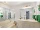 Large bathroom with soaking tub, double vanity, and framed mirrors at 3003 Hanover Se Ln, Conyers, GA 30094