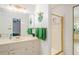 Bright bathroom featuring a vanity, walk-in shower with gold trim, and a view to the tub at 3003 Hanover Se Ln, Conyers, GA 30094