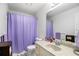 Bathroom featuring vanity, toilet, and shower with purple curtain at 3003 Hanover Se Ln, Conyers, GA 30094