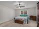 Cozy bedroom with neutral carpet, ceiling fan, and a view of the backyard at 3003 Hanover Se Ln, Conyers, GA 30094