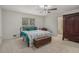Comfortable bedroom with a view of backyard, ceiling fan, and dresser at 3003 Hanover Se Ln, Conyers, GA 30094