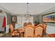 Formal dining room under a vaulted ceiling features a wrought iron chandelier at 3003 Hanover Se Ln, Conyers, GA 30094
