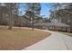 View of brick home on large lot with mature trees and a winding driveway offering plenty of parking at 3003 Hanover Se Ln, Conyers, GA 30094