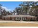 Charming brick home with a well-manicured lawn and mature trees in a desirable neighborhood at 3003 Hanover Se Ln, Conyers, GA 30094
