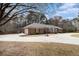 Brick home with an attached garage, basketball hoop, and circular driveway with space for recreation at 3003 Hanover Se Ln, Conyers, GA 30094