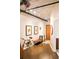 Hallway with exposed ductwork, wood floors, stylish artwork, and convenient bench at 878 Peachtree St # 625, Atlanta, GA 30309