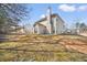 Wide view of the home's backyard, showing the spacious area and exterior elevation on a sunny day at 9630 Carolina Drive, Jonesboro, GA 30238