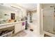 Bathroom featuring a large vanity with storage, a soaking tub, and a glass-enclosed shower at 9630 Carolina Drive, Jonesboro, GA 30238