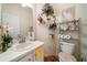 Powder room features a large vanity, floral decor and hardwood floors at 9630 Carolina Drive, Jonesboro, GA 30238