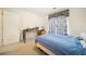 Cozy bedroom with neutral carpet, featuring a desk by the window at 9630 Carolina Drive, Jonesboro, GA 30238