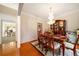 Formal dining room with wainscoting, chandelier, table and chairs, and hardwood floors at 9630 Carolina Drive, Jonesboro, GA 30238