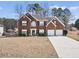 Charming two-story brick home with well-maintained lawn and two-car garage, perfect for Gathering living at 9630 Carolina Drive, Jonesboro, GA 30238