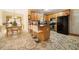 Open kitchen area with breakfast bar, black appliances, and eat-in table at 9630 Carolina Drive, Jonesboro, GA 30238
