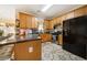 Well-lit kitchen featuring granite countertops, wooden cabinetry, and modern stainless steel appliances at 9630 Carolina Drive, Jonesboro, GA 30238