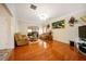 Comfortable living room featuring hardwood floors, neutral walls, and plush reclining furniture at 9630 Carolina Drive, Jonesboro, GA 30238