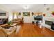Bright living room featuring hardwood floors, a fireplace, and comfortable seating at 9630 Carolina Drive, Jonesboro, GA 30238