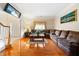 Cozy living room with hardwood floors, large sectional, and natural light creates an inviting space at 9630 Carolina Drive, Jonesboro, GA 30238