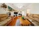 Comfortable living room with hardwood floors, fireplace, and large sofas provides ample seating at 9630 Carolina Drive, Jonesboro, GA 30238