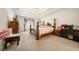Comfortable bedroom featuring a ceiling fan, tray ceiling, and a large window for natural light at 9630 Carolina Drive, Jonesboro, GA 30238