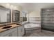 Bathroom featuring double vanity, soaking tub, and glass enclosed shower with tiled surround at 1964 Hollywood Nw Rd, Atlanta, GA 30318