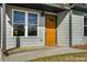 Close-up of the home's entry featuring a brightly colored door and covered porch at 1964 Hollywood Nw Rd, Atlanta, GA 30318